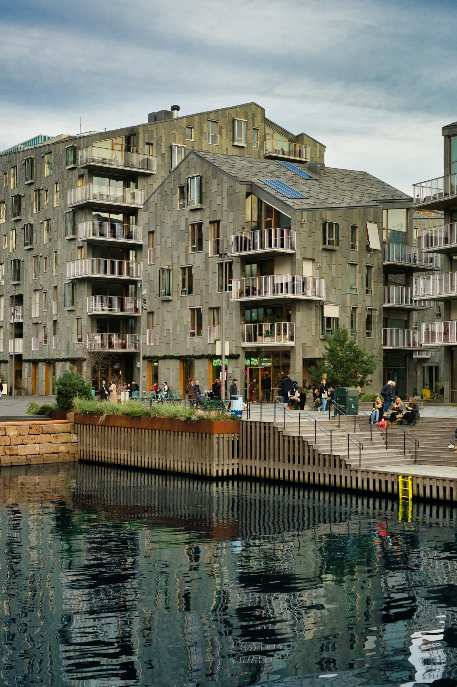 Modern waterfront buildings reflected in calm water